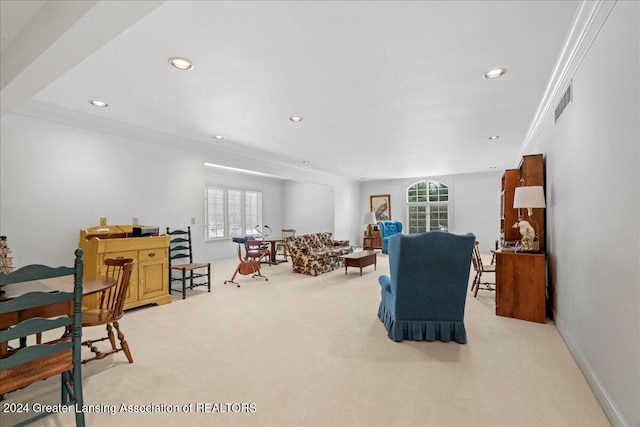 carpeted living room with a wealth of natural light and ornamental molding