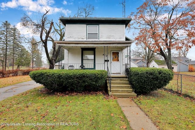 front facade featuring a front lawn and covered porch