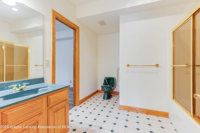 bathroom with vanity and shower / bath combination with glass door