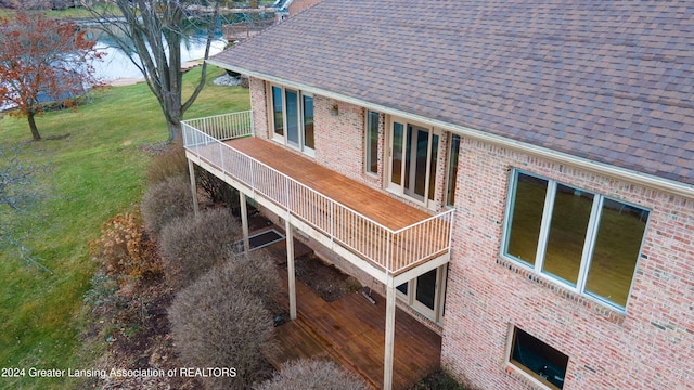 view of property exterior with a deck and a lawn