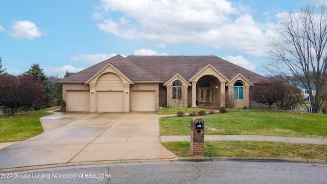 ranch-style home with a garage and a front yard