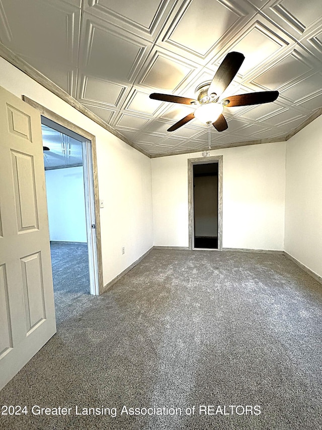 carpeted spare room with ceiling fan