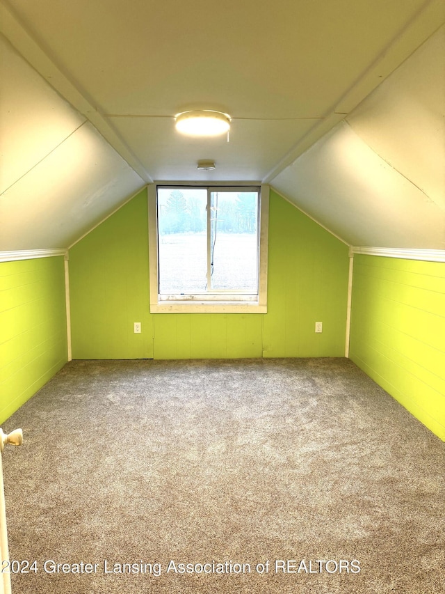 bonus room featuring lofted ceiling and carpet floors