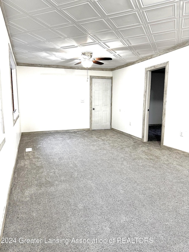 empty room featuring carpet flooring and ceiling fan