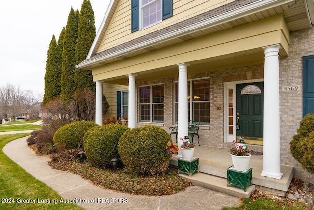 view of exterior entry with a porch