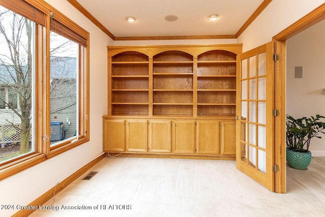 carpeted empty room featuring french doors and ornamental molding