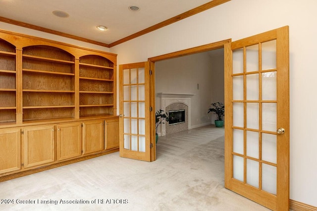 spare room featuring light carpet, french doors, and ornamental molding