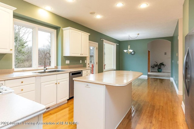 kitchen featuring dishwasher, sink, hanging light fixtures, a kitchen island, and white cabinets