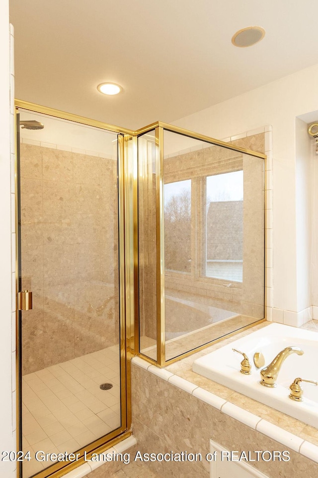 bathroom with tile patterned floors and separate shower and tub