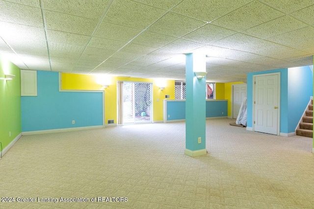 basement with carpet and a paneled ceiling