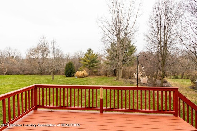 wooden terrace featuring a yard