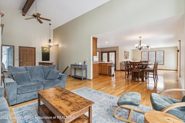 living room with beam ceiling, light hardwood / wood-style flooring, and a healthy amount of sunlight