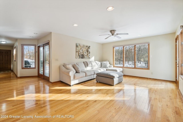 living room with ceiling fan and light wood-type flooring