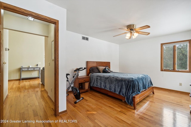 bedroom with ceiling fan and light hardwood / wood-style flooring