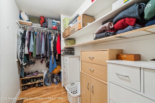 spacious closet featuring light hardwood / wood-style floors