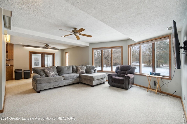 carpeted living room featuring french doors, a textured ceiling, and ceiling fan