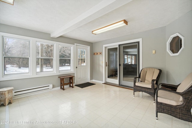 sitting room with beam ceiling, a textured ceiling, and a baseboard heating unit