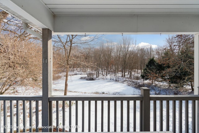 yard covered in snow with a balcony