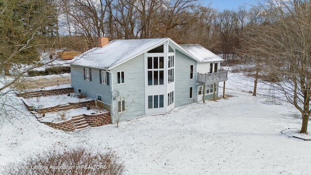 view of snowy exterior featuring a balcony