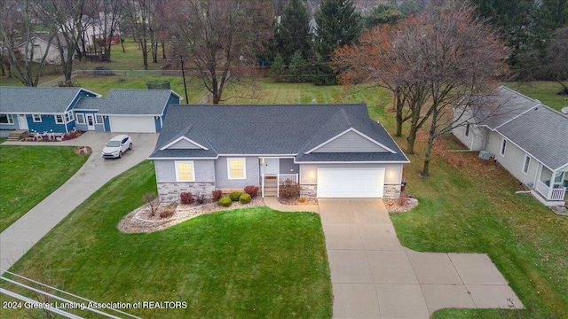 view of front of house featuring a garage and a front lawn