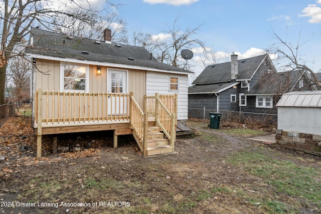 back of house featuring a deck