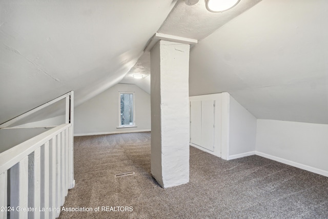 bonus room with carpet and vaulted ceiling