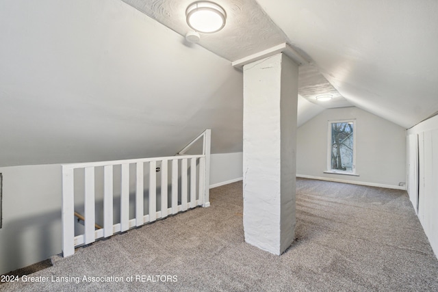 bonus room with carpet and vaulted ceiling