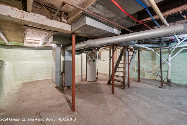 basement featuring heating unit and water heater