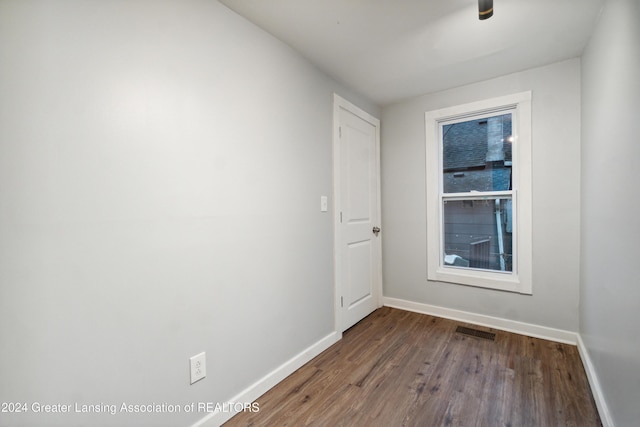 empty room with dark wood-type flooring