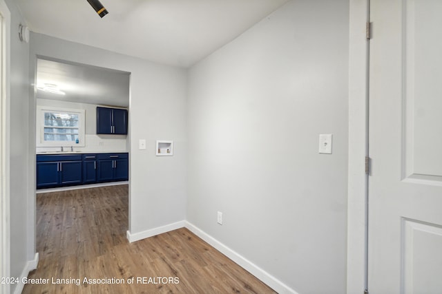 hallway featuring sink and light hardwood / wood-style floors