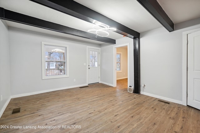 entrance foyer featuring beam ceiling and light wood-type flooring