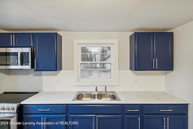 kitchen featuring range with electric stovetop, backsplash, sink, and blue cabinets