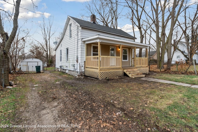 view of front facade with covered porch and a storage unit