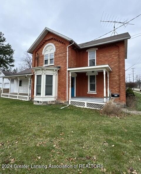 view of front of house with a front yard and a porch