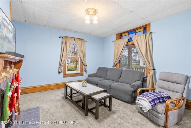 living room featuring carpet floors and a healthy amount of sunlight