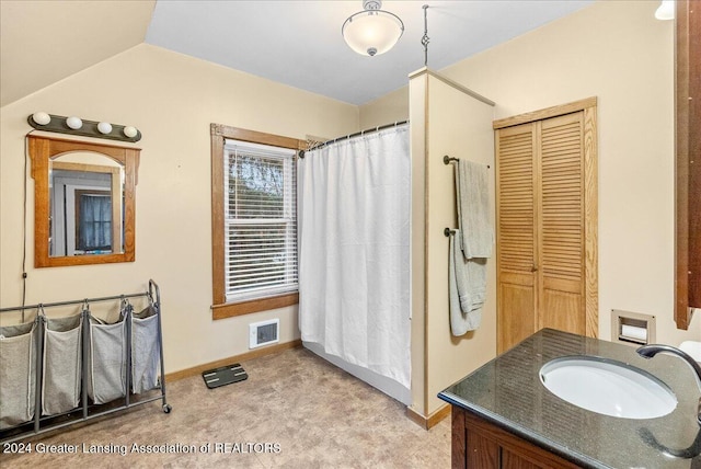 bathroom featuring vanity and vaulted ceiling