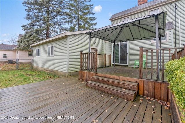 wooden terrace featuring a gazebo