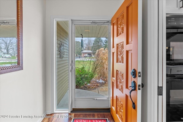 doorway with dark hardwood / wood-style flooring