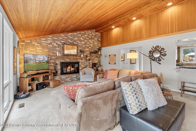 living room with carpet floors, high vaulted ceiling, a brick fireplace, beam ceiling, and wood ceiling