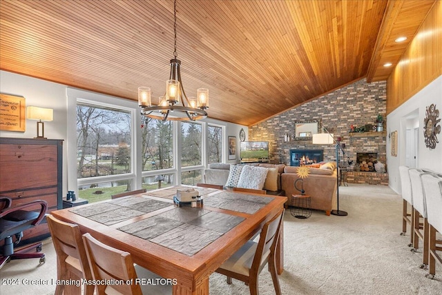 carpeted dining area with a large fireplace, wooden ceiling, high vaulted ceiling, and an inviting chandelier