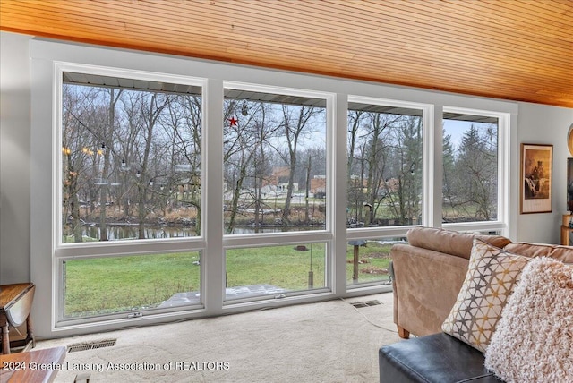 unfurnished sunroom with a water view and wood ceiling