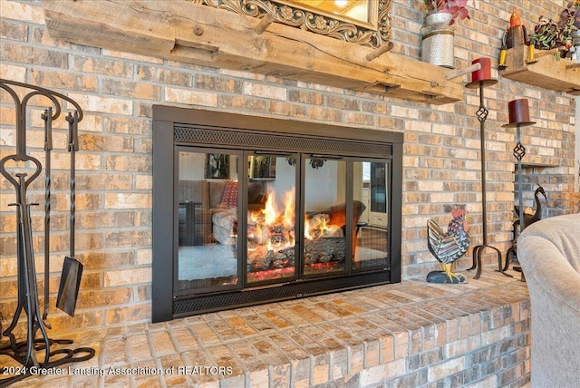 interior details featuring a brick fireplace