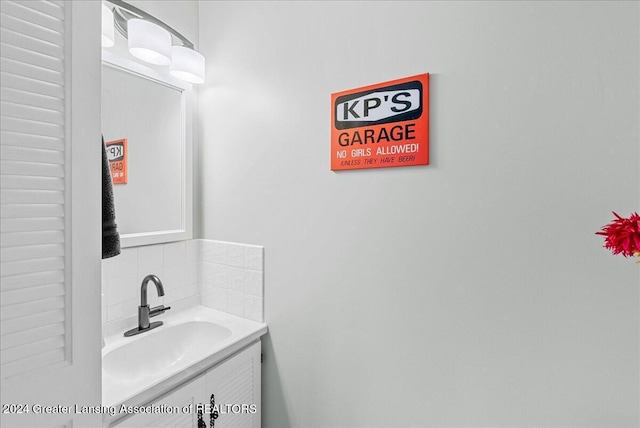 bathroom featuring vanity and backsplash