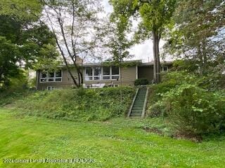 rear view of property with a yard