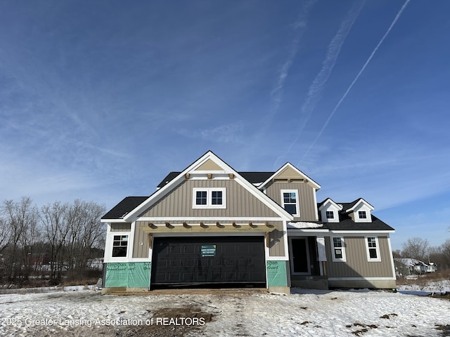 view of front of home featuring a garage, roof with shingles, and board and batten siding