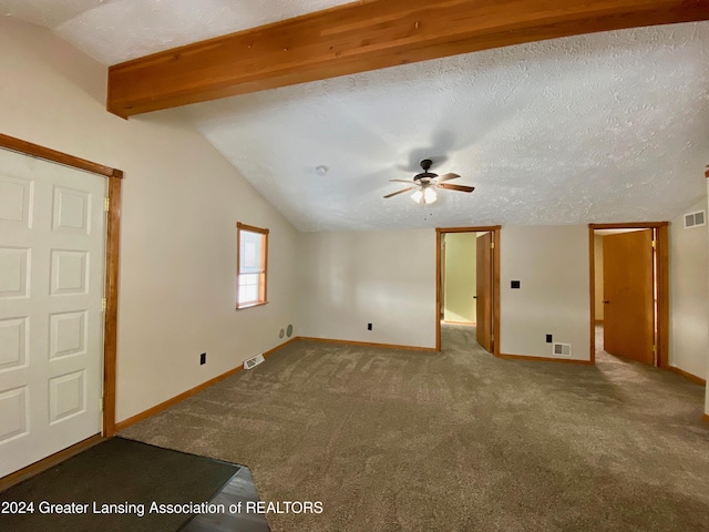 unfurnished room with carpet, lofted ceiling with beams, ceiling fan, and a textured ceiling