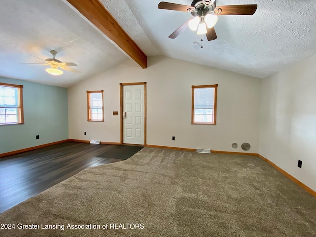 spare room featuring a wealth of natural light, dark hardwood / wood-style flooring, and a textured ceiling