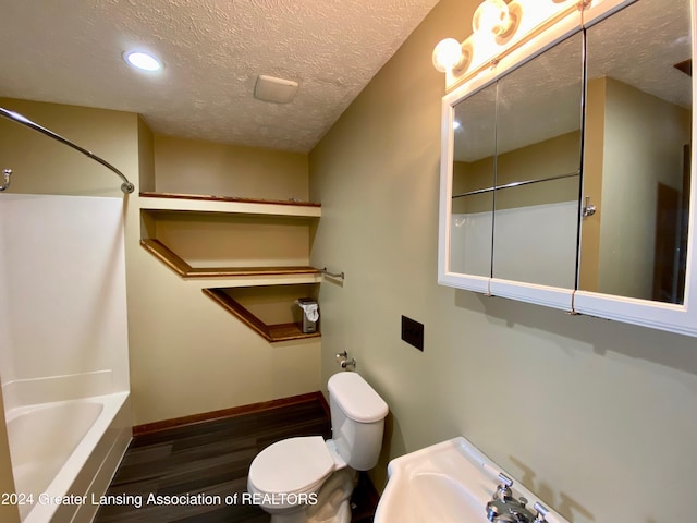 bathroom featuring toilet, wood-type flooring, a textured ceiling, and shower / tub combination