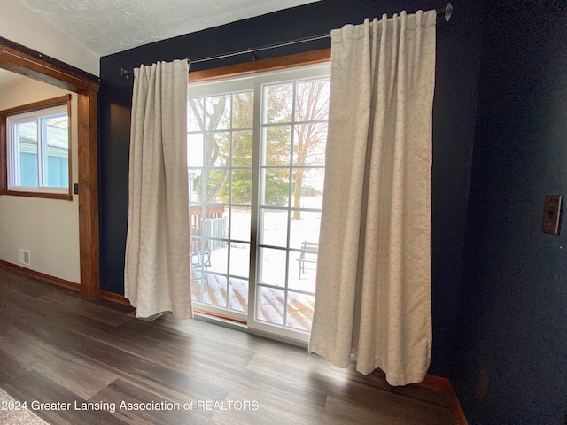 doorway to outside featuring hardwood / wood-style floors and a textured ceiling