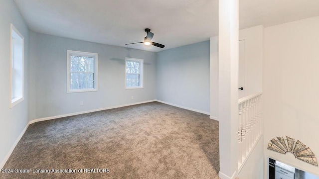 unfurnished room featuring ceiling fan and carpet floors